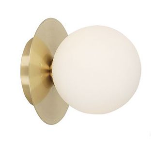 Brass wall light on white background