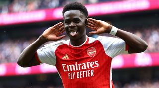 Bukayo Saka celebrates after scoring for Arsenal against Tottenham in April 2024.