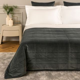 Luxury Cashmere Quilt in Heather Gray on a bed.