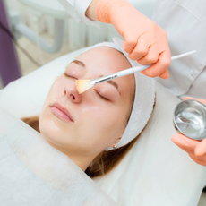 Aesthetician Or Dermatologist Portrait Cosmetologist applying mask on client's face in spa salon. Wellness center. Healthcare occupation - stock photo