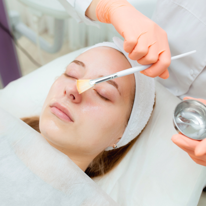 Aesthetician Or Dermatologist Portrait Cosmetologist applying mask on client's face in spa salon. Wellness center. Healthcare occupation - stock photo