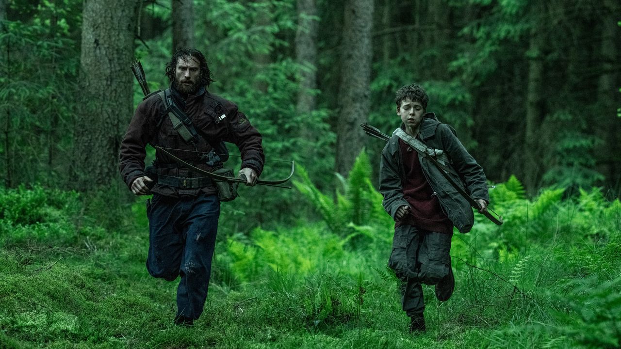 Two men running through a forest in 28 Years Later