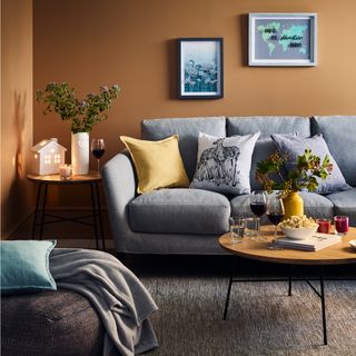 living room with allium wall art ceramic heart vase soft ochre cushion deer cushion and ceramic ochre vase