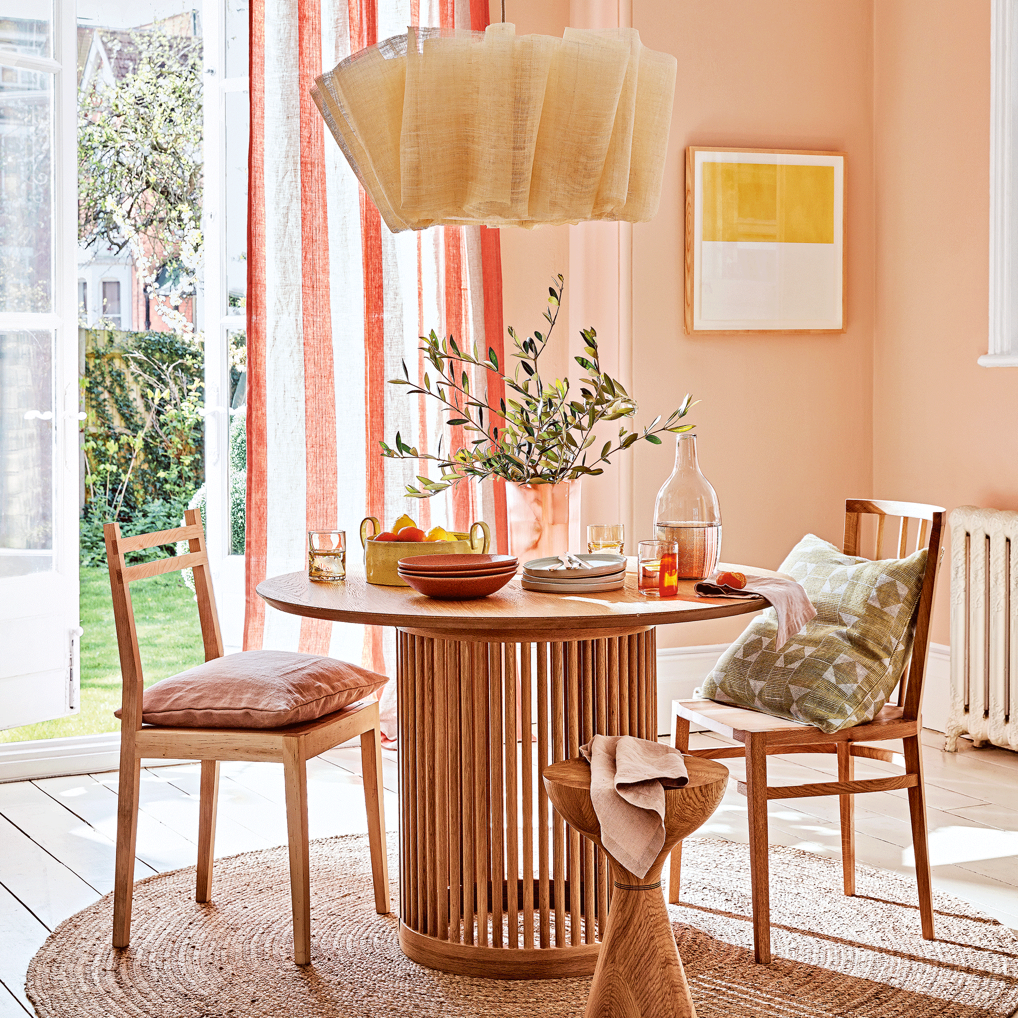 Pink dining room with wooden table and chairs