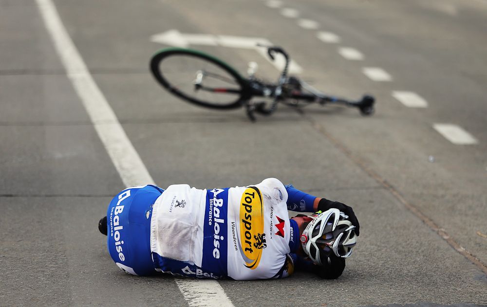 Eliot Lietaer of Belgium and Topsport Vlaanderen - Baloise lies on the ground after crashing during the race in 2013.