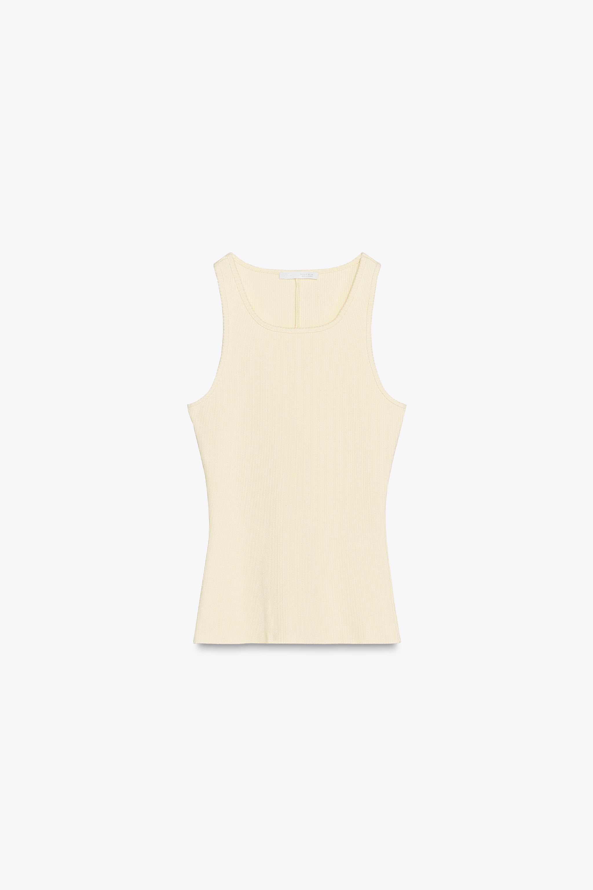 Cream colored, ribbed top with thick straps.