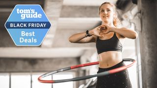 Woman using a hula hoop during workout and Tom's Guide Black Friday deals badge top left