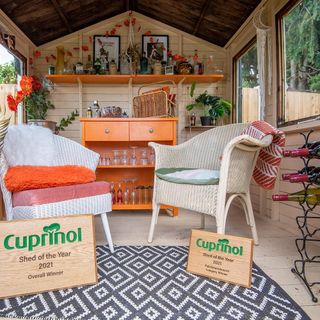 Danielle Zarb-Cousin's shed of the year interior with a retro orange cocktail bar and wicker furniture