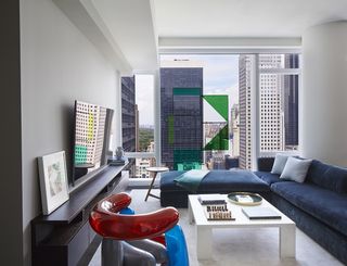 blue sofa and green art in Baccarat Residence NYC Architect Joe Serrins Studio