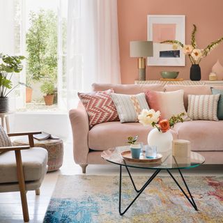 pink living room with french doors and pink sofa