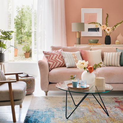 Pink living room with french doors and a pink sofa