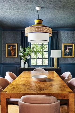 blue dining room with wooden table and pink chairs