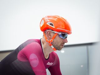 Tom riding in the wind tunnel wearing an aero helmet