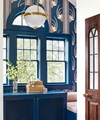 nook with window seat and bold blue wallpaper