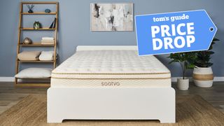 The Saatva Classic, our highest rated mattress, on a bed frame in a bedroom. A Tom's guide price drop deals graphic in the top right corner