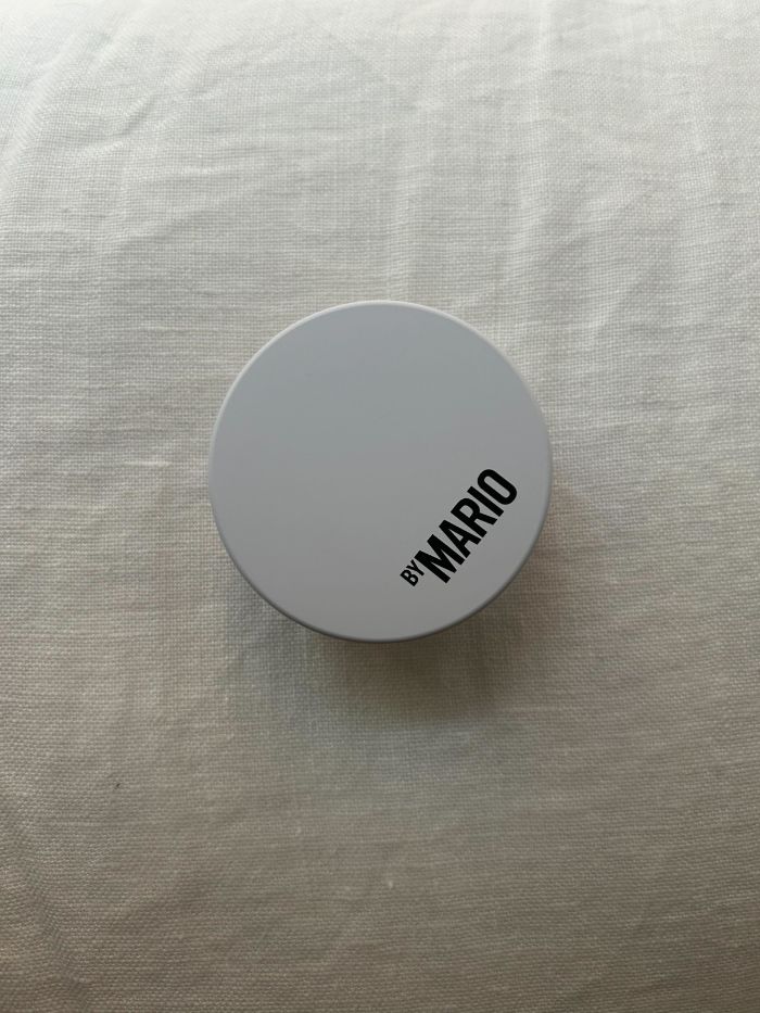 The Makeup By Mario Surrealskin Soft Blur Setting Powder on a white linen background