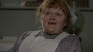 Lesley Nicol smiles as she tries to explain something in the downstairs kitchen in Downton Abbey.