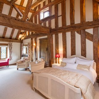 master bedroom with wooden beams and french style furniture