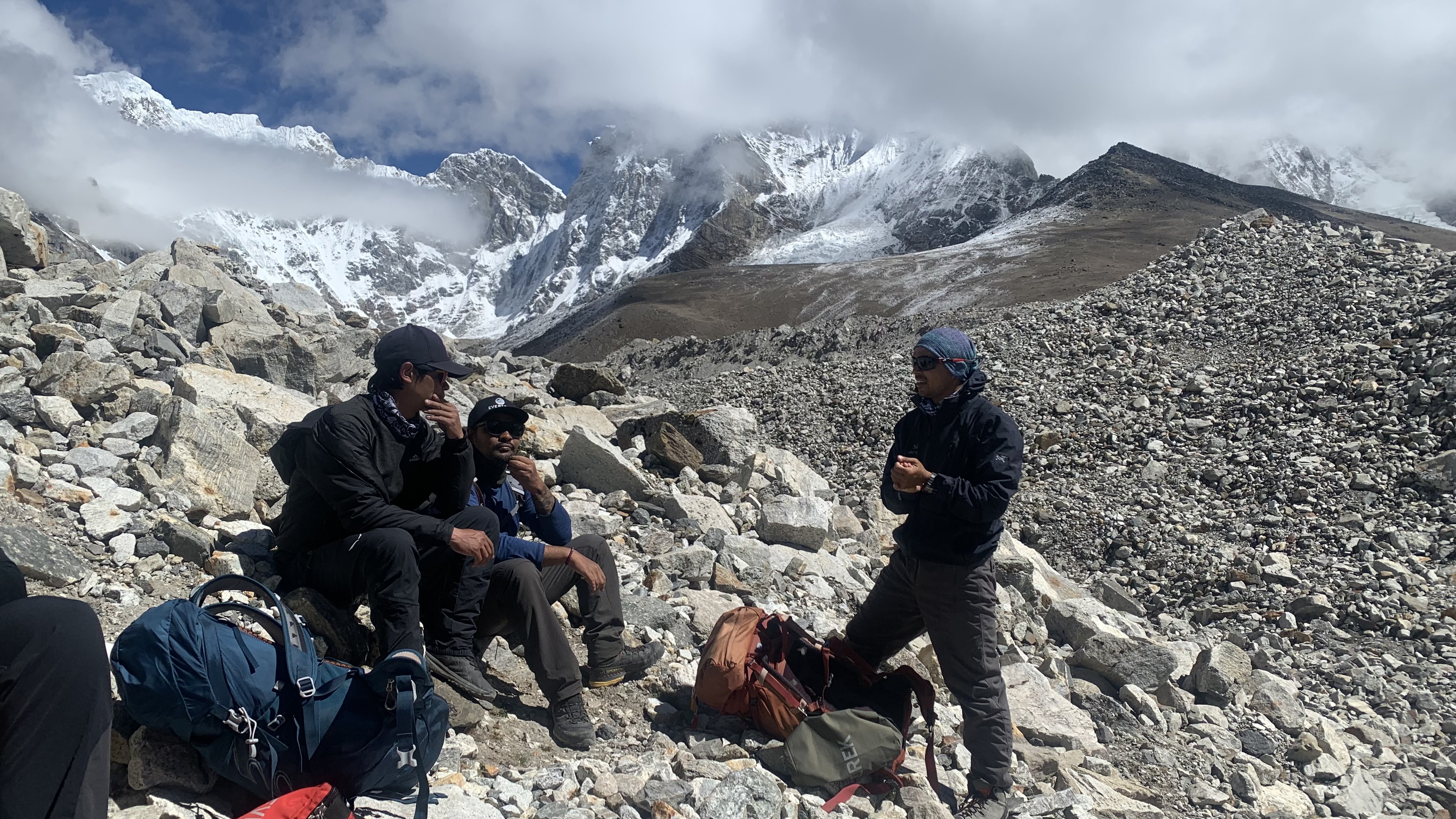 Nepalese guides rest on the rocks on the trek to Everest Base Camp