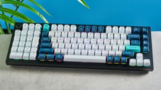 the keychron q12 max southpaw keyboard in navy blue with white and teal keycaps and red jupiter gateron switches