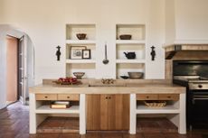 A kitchen with a neutral palette and wooden features