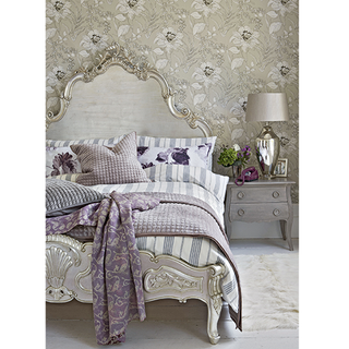 bedroom with patterened wallpaper