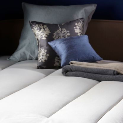 bedroom with wool mattress and designer cushions