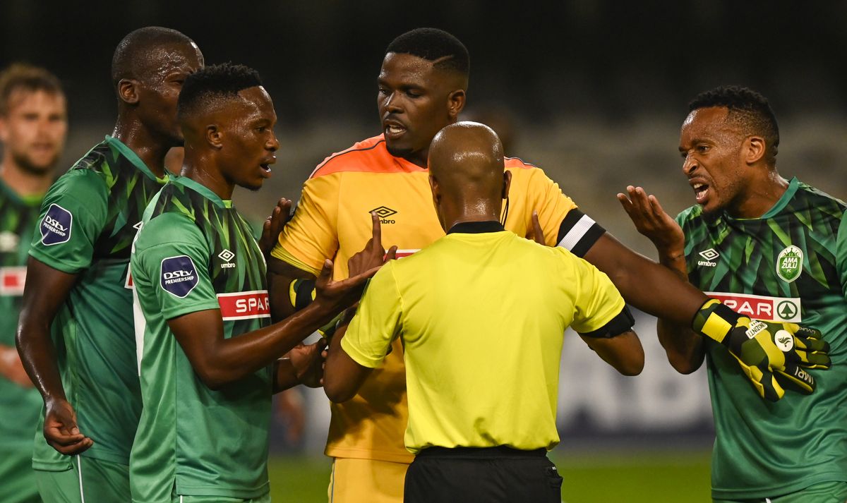 Siyabonga Mbatha tries to keep the players calm during a penalty disagreement 