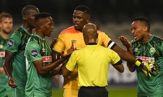 Siyabonga Mbatha tries to keep the players calm during a penalty disagreement 