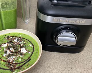 Pea soup in bowl made using KitchenAid K150 blender