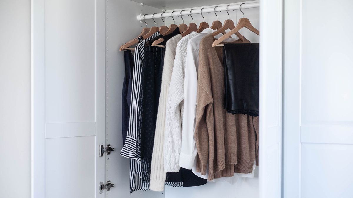 Clothes hanging in white closet