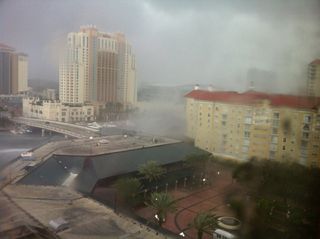 The Tampa waterspout transformed into a tornado when it hit land, damaging roofs and five vehicles.