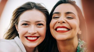 two women wearing red lipstick