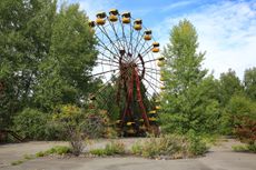A ferris wheel sits unused in an amusement park that never opened in the abandoned Pripyat city within Chernobyl's exclusion zone. 
