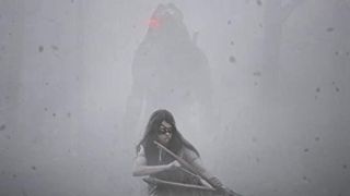 Girl holds a bow and arrow with Predator appearing from the fog behind her
