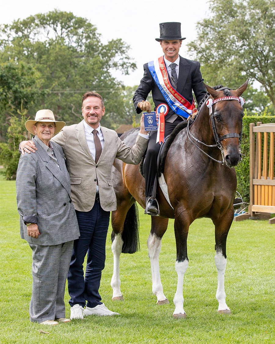 Harrison Taylor riding Lostock Up Till Dark at Royal International Horse Show is presented with award