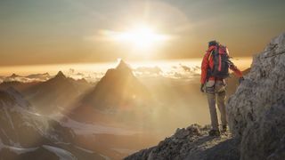 A woman climber watching Matterhorn at sunset