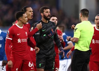 LIVERPOOL, ENGLAND - APRIL 24: Trent Alexander-Arnold, Virgil van Dijk and Alisson Becker of Liverpool react towards Referee Andrew Madley after he awards Everton a penalty following a foul on Dominic Calvert-Lewin of Everton (not pictured) by Alisson Becker of Liverpool which is later overturned following a VAR review during the Premier League match between Everton FC and Liverpool FC at Goodison Park on April 24, 2024 in Liverpool, England. (Photo by Naomi Baker/Getty Images)