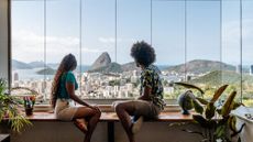 Couple on holiday in Rio de Janeiro, sitting at table, enjoying the view