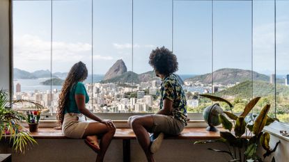 Couple on holiday in Rio de Janeiro, sitting at table, enjoying the view