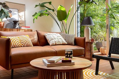 A coffee table and sofa with vibrant patterned cushions