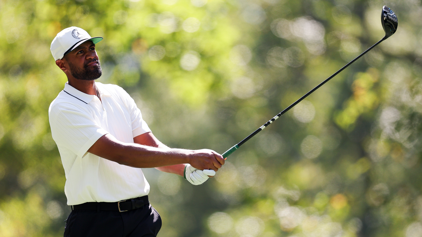Tony Finau hits a driver and watches the flight