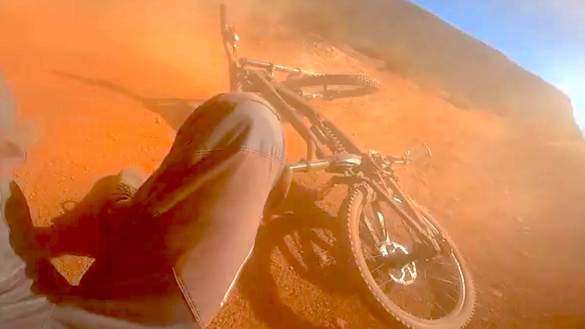 Watch mountain biker crash after being blown off course in mid air ...