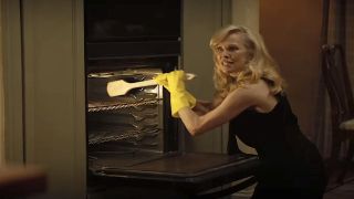 Beth cleaning oven in The Naked Gun reboot