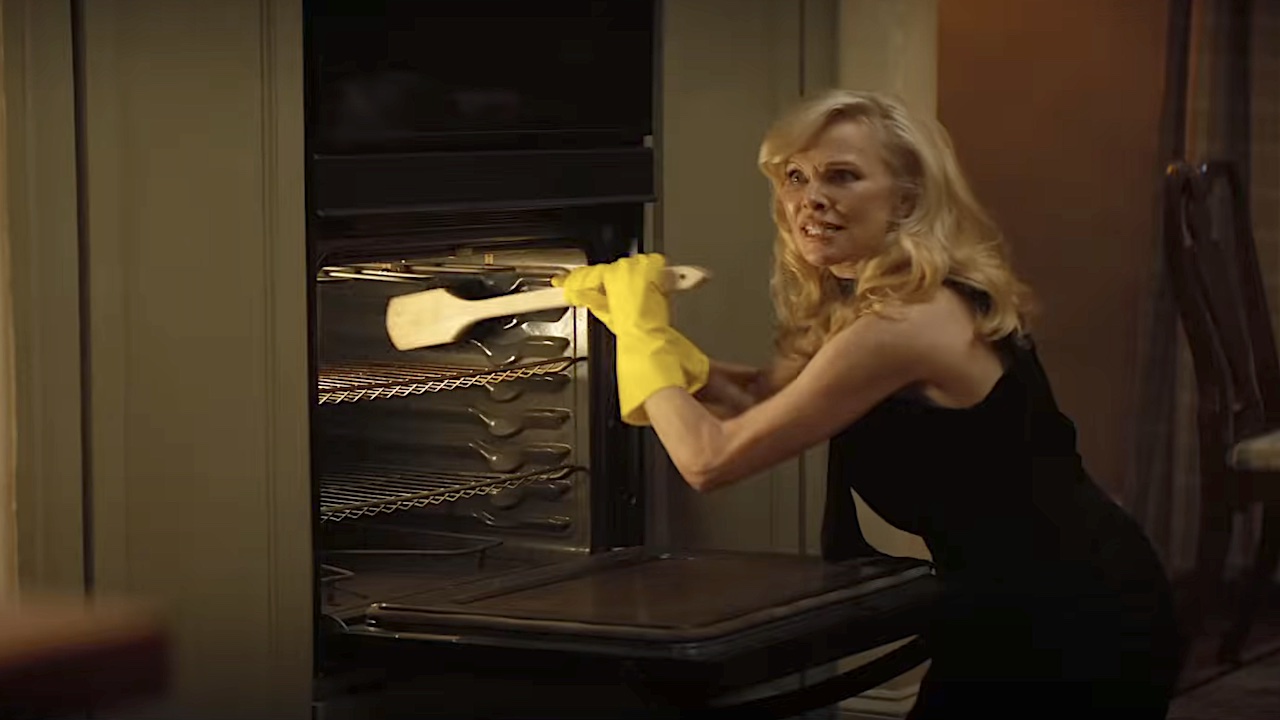 Beth cleaning oven in The Naked Gun reboot