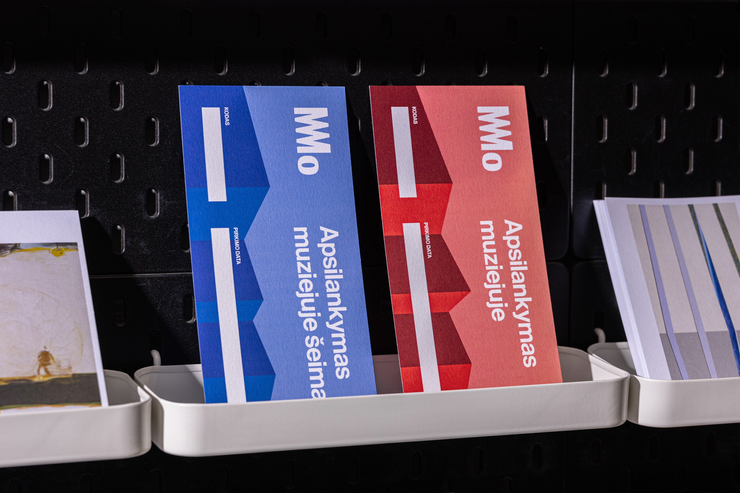 Mo museum promotional materials on blue and red card