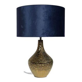 table lamp with hammered brass base and blue velvet shade