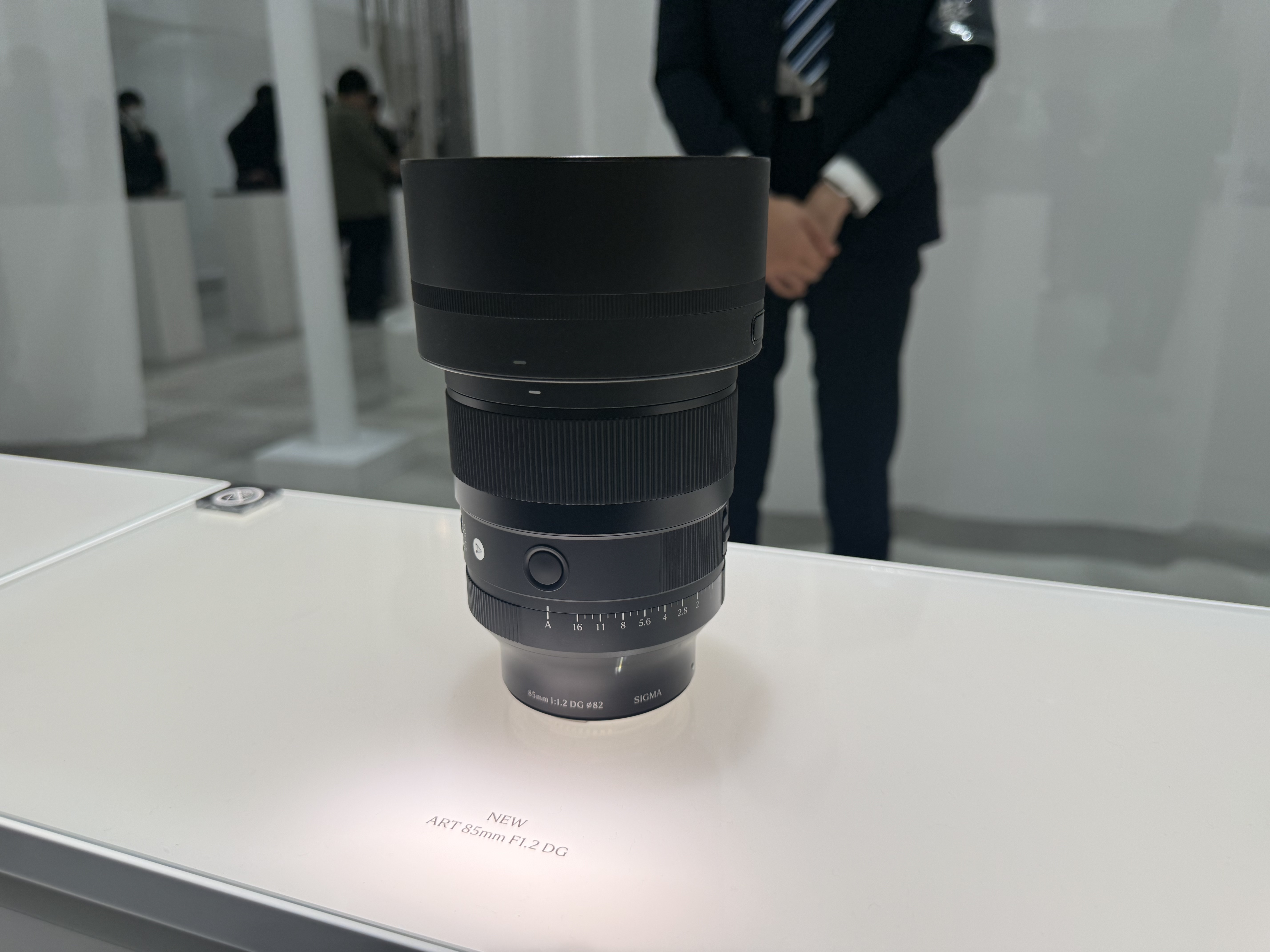 Sigma's 85mm F1.2 DG Art lens on a white display surface at the CP+ 2026 show in Japan