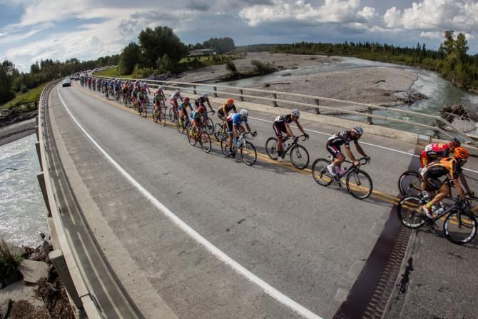 The peloton passes one of the recently-flooded rivers on the way into town.