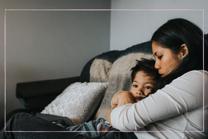 A mother holds her sky little boy close to her chest, and he tenderly rests his head on her 